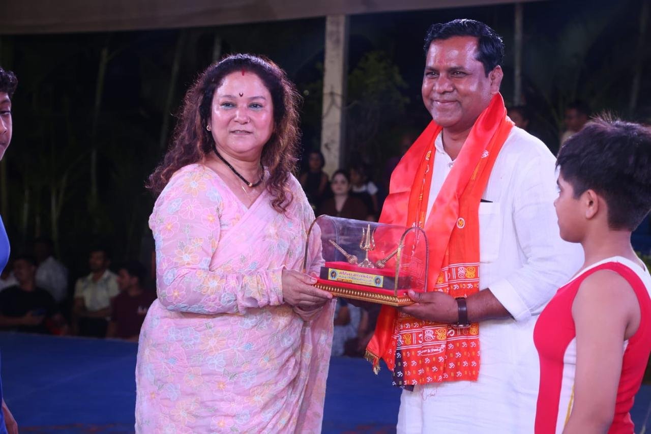A wrestler being felicitated at an evening event