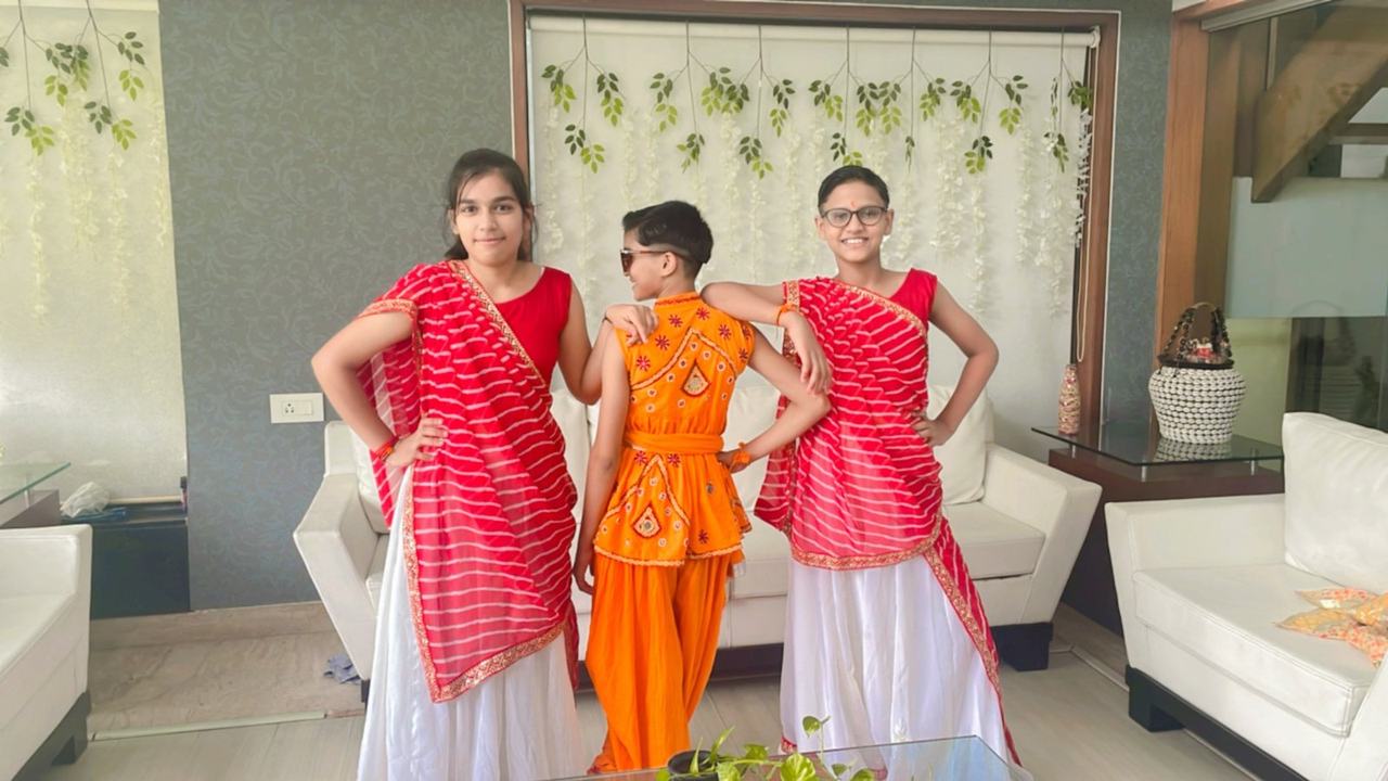 Three girls in orange festival dresses