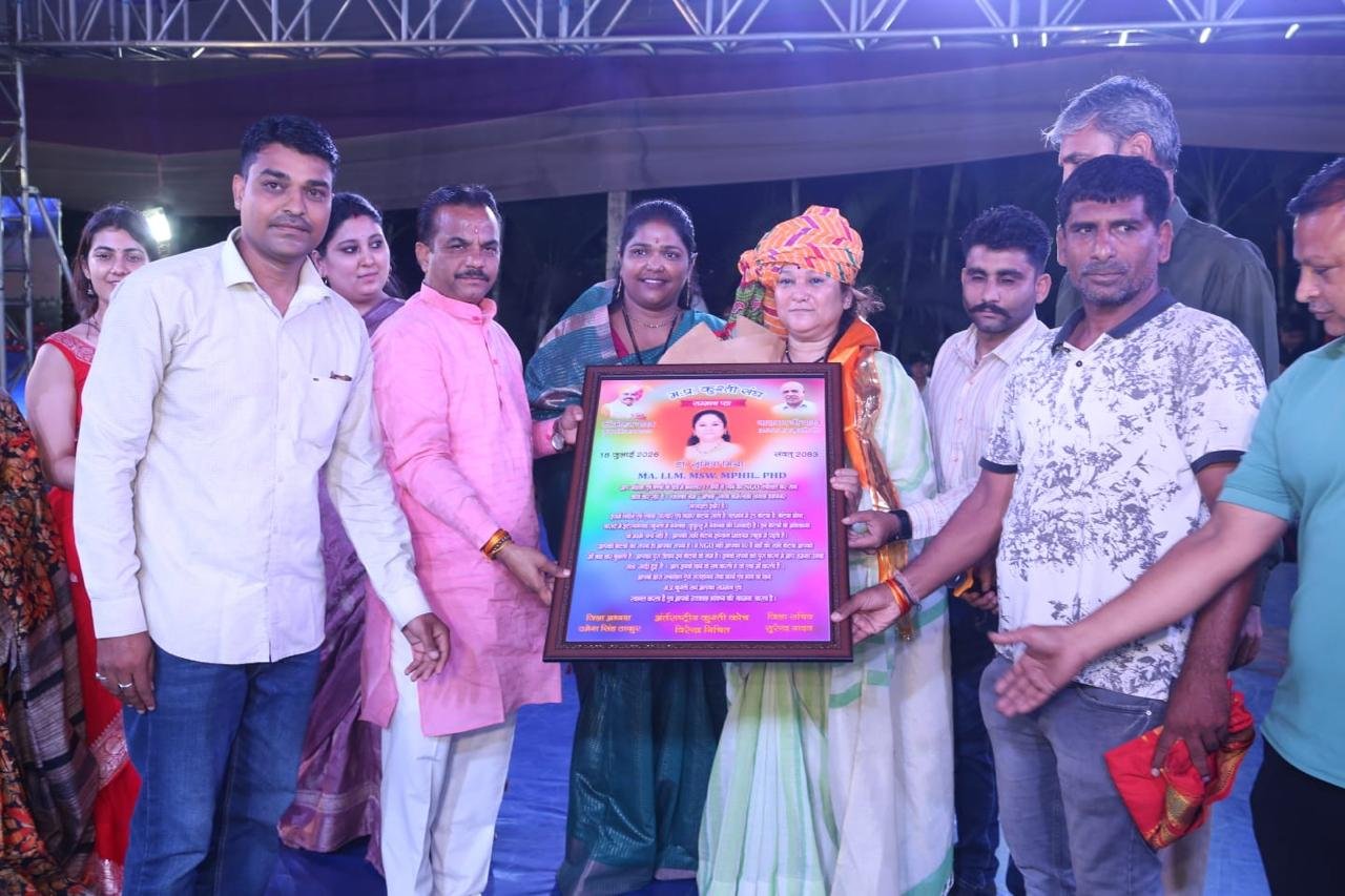 A framed award being presented at a Shiv Karmsthali event