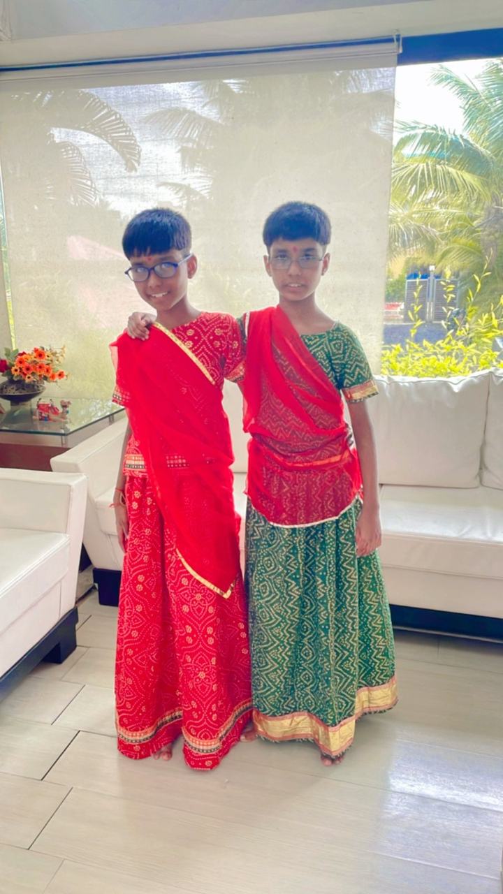 Two boys in red and green festival costumes