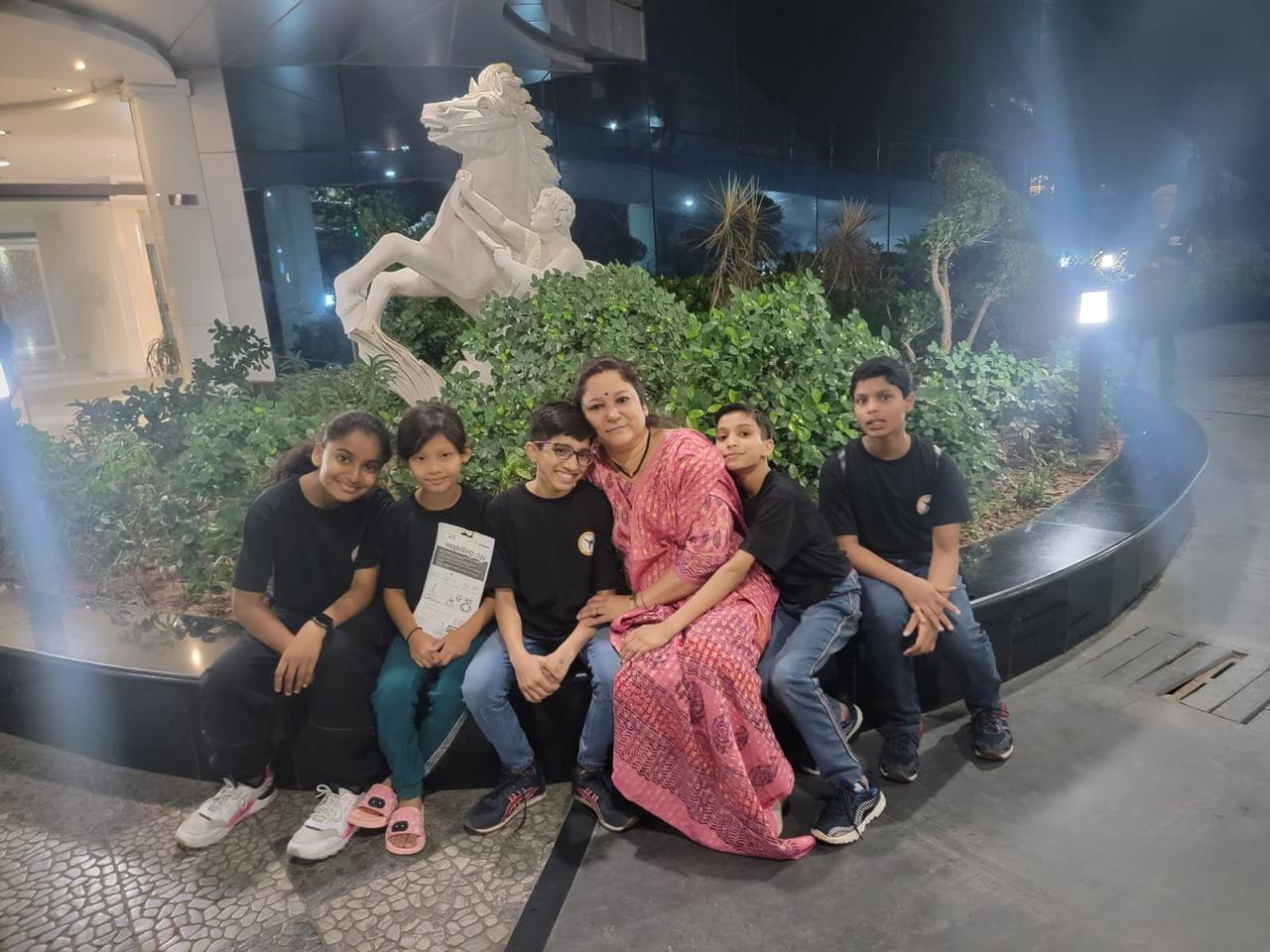 Children in school uniform with founder Sumitra Mishra