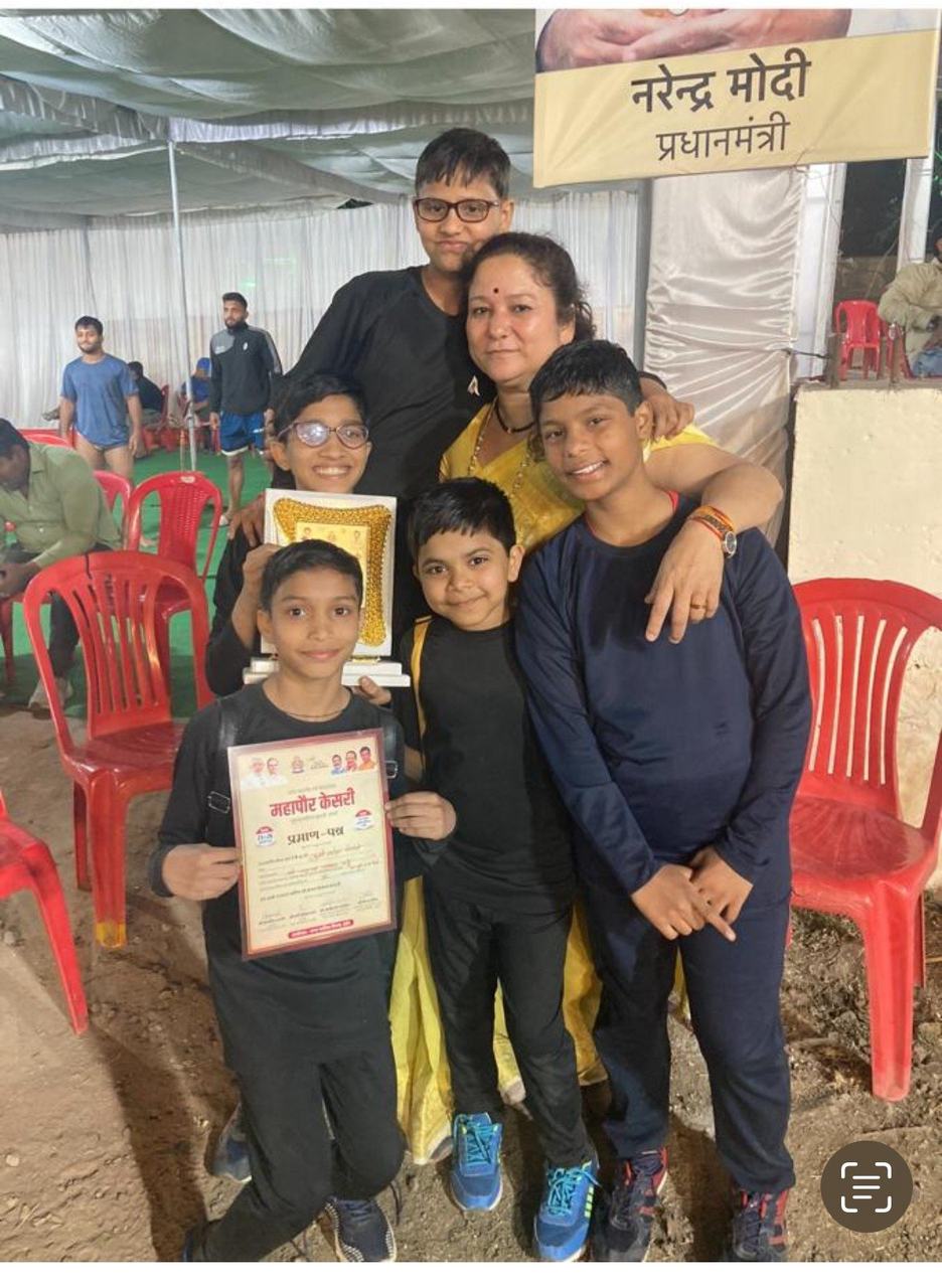 Founder Sumitra Mishra with a child and an award