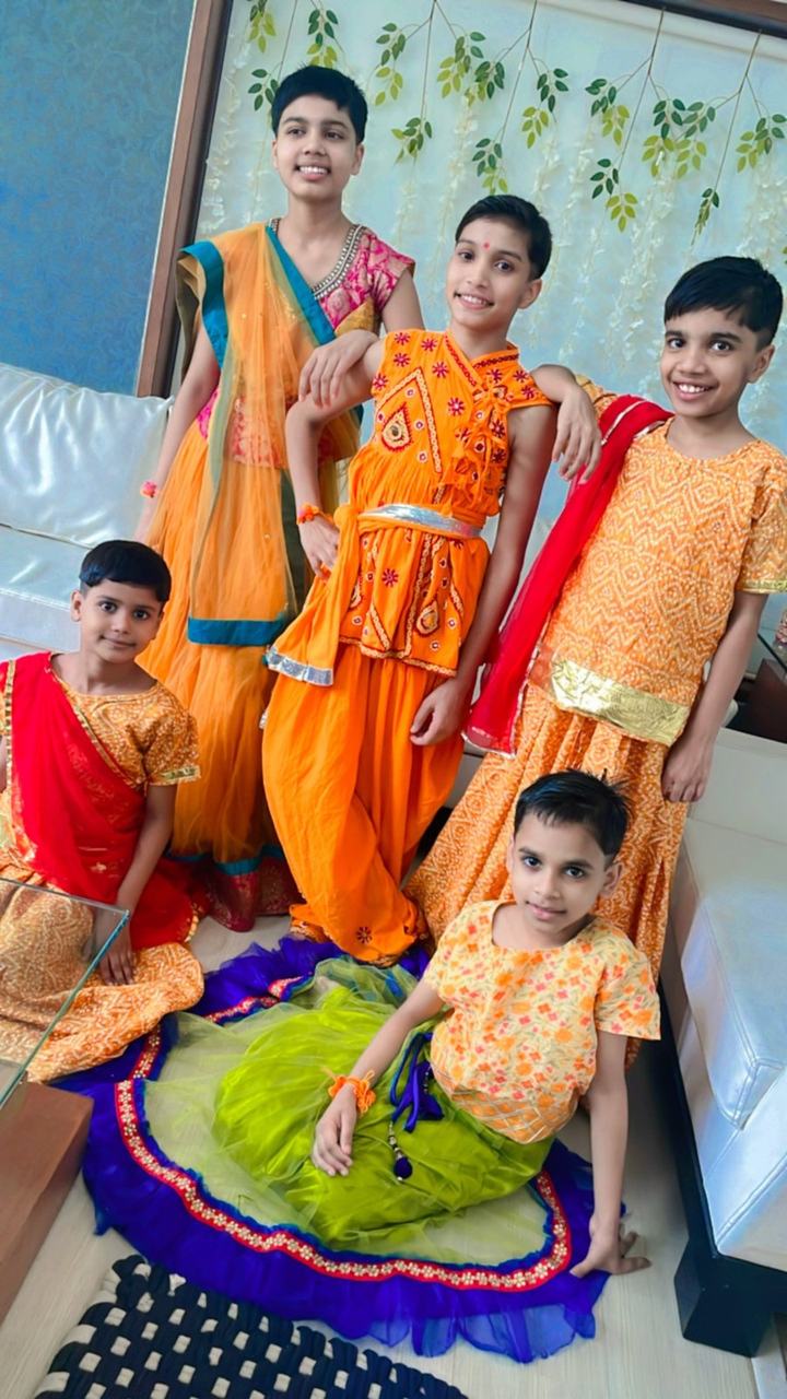 Three children in matching festival costumes
