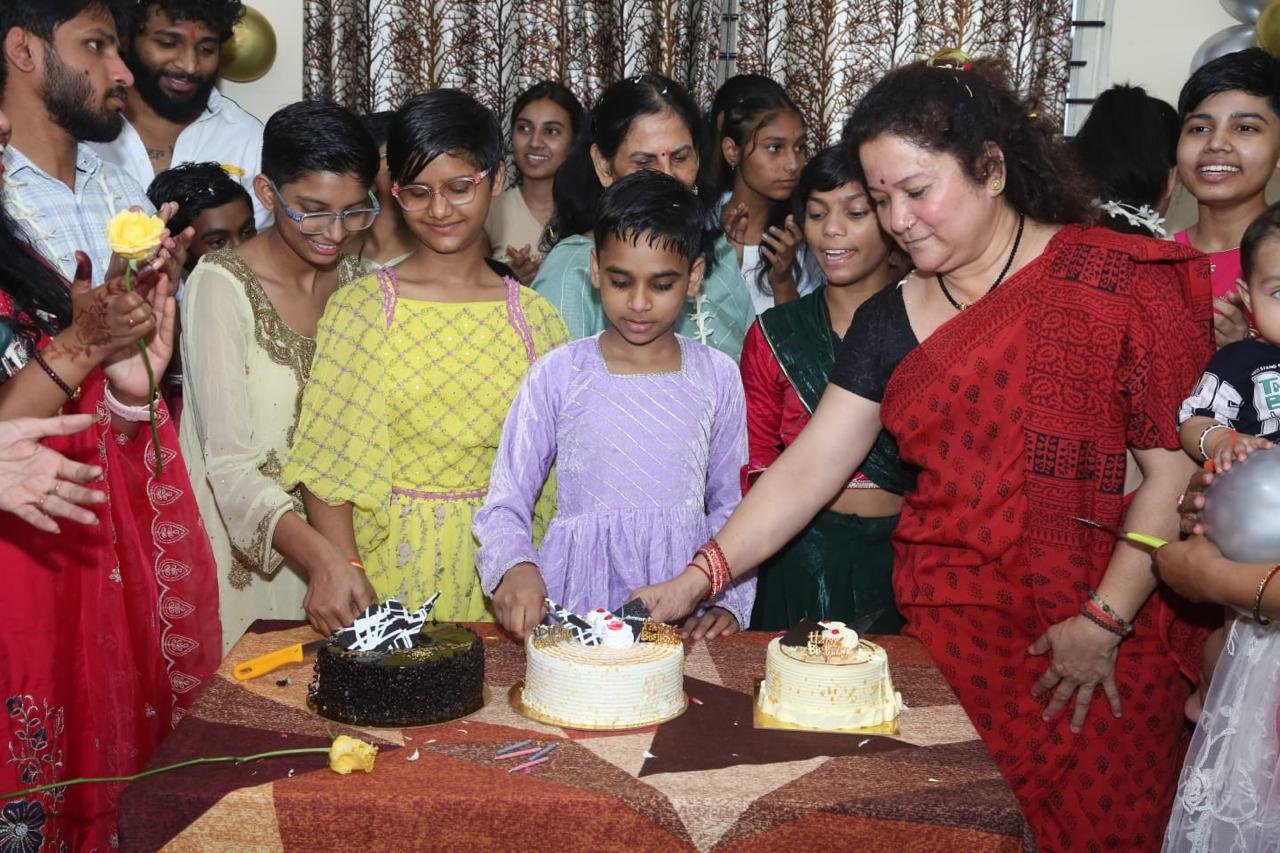 Girls cutting cake together at a celebration